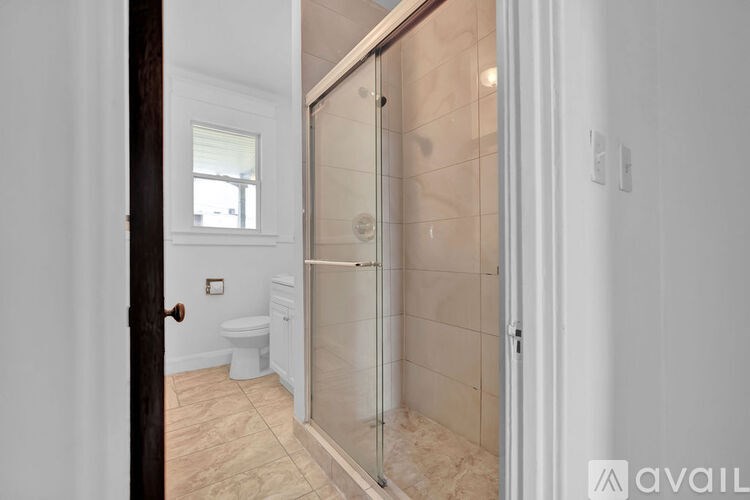 A bathroom with a walk-in shower and a toilet.