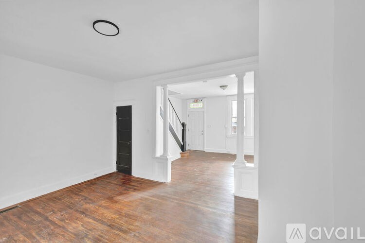 A room with wooden floors and white walls.