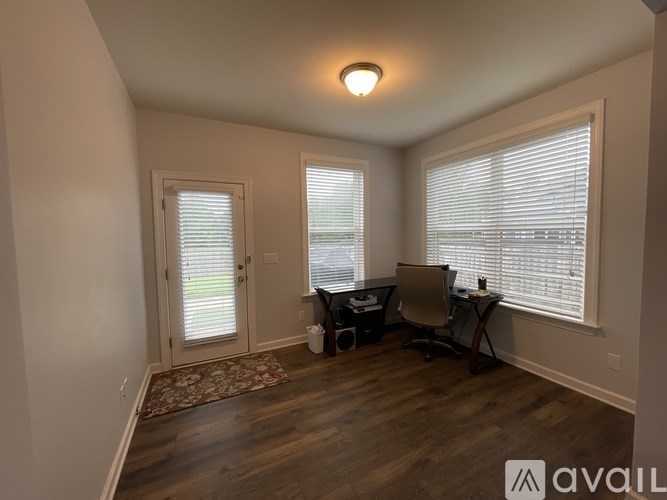 A room with a desk and a chair in it.