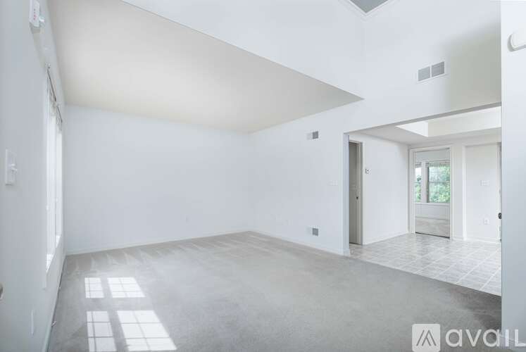 A spacious room with a tiled floor and a skylight.