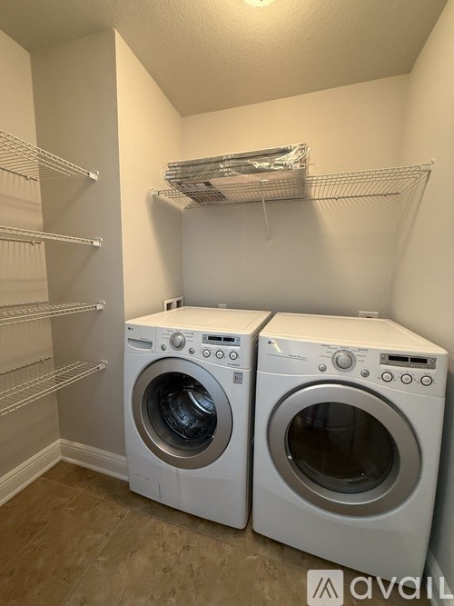 A laundry room with two front loading washing machines.
