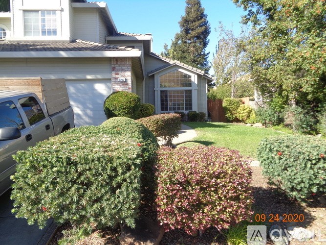 A house with a white van parked in front of it.
