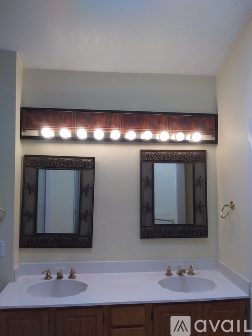 A bathroom with a tub and a window with blinds.