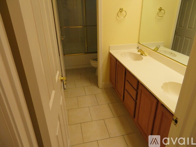 A bathroom with a sink, mirror, and toilet.