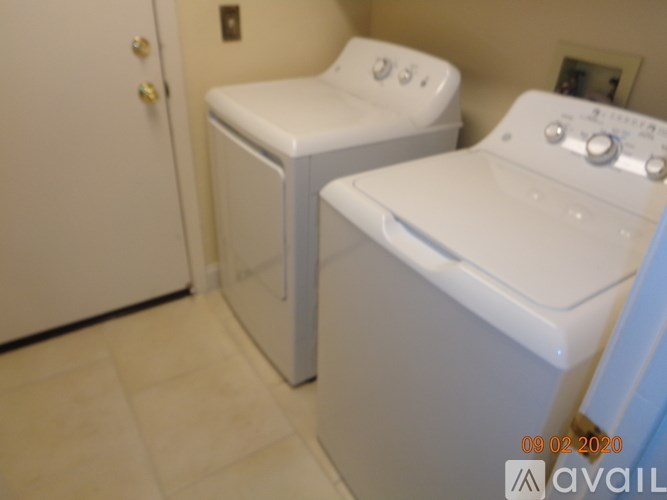 A white washing machine and dryer in a small laundry room.