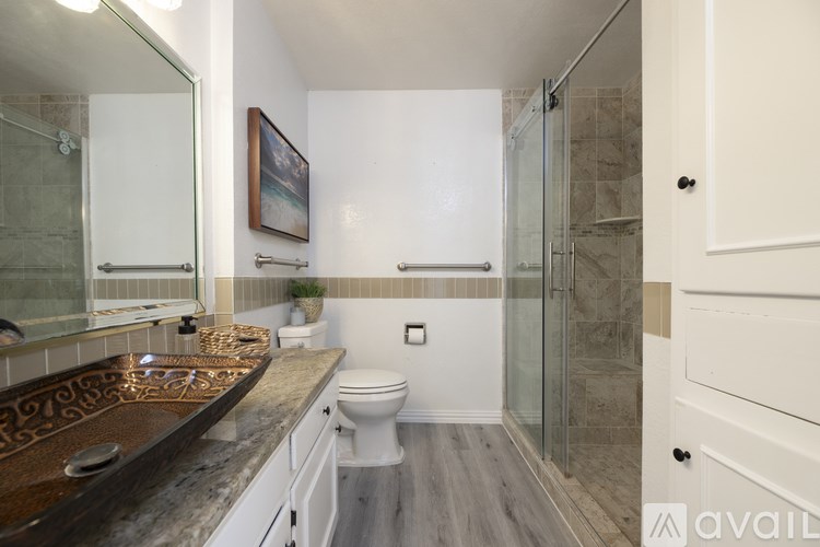 A bathroom with a toilet, sink, and shower.