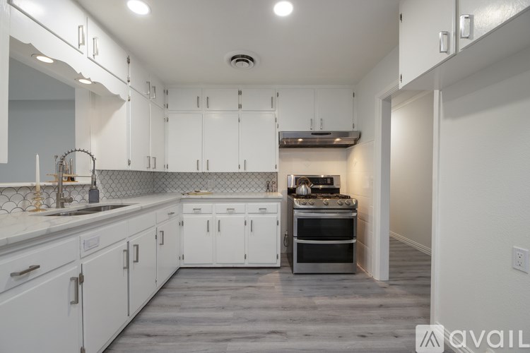A bathroom with a white sink and a mirror above it.