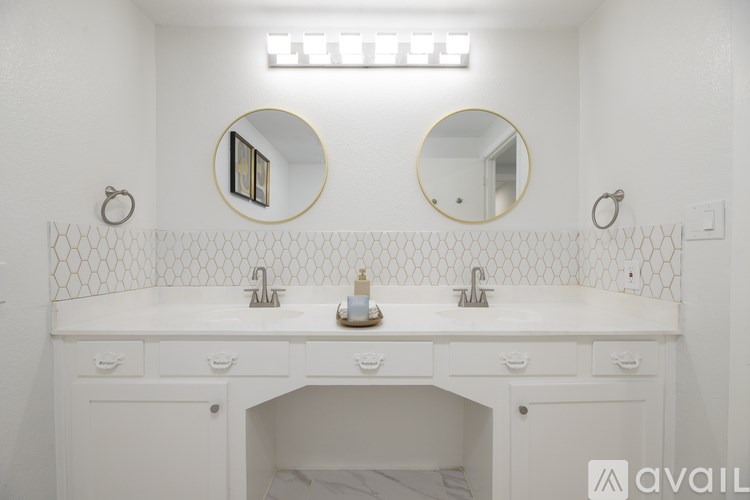 A bathroom with two sinks and two mirrors.