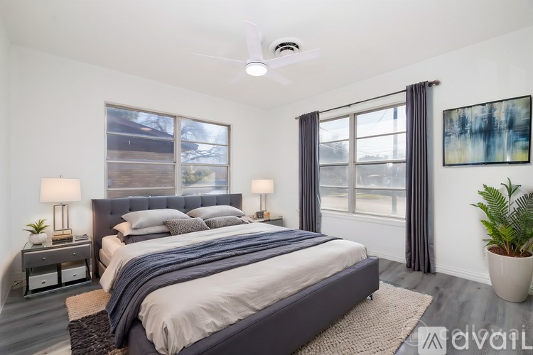 A large, empty room with a fireplace and a chandelier.