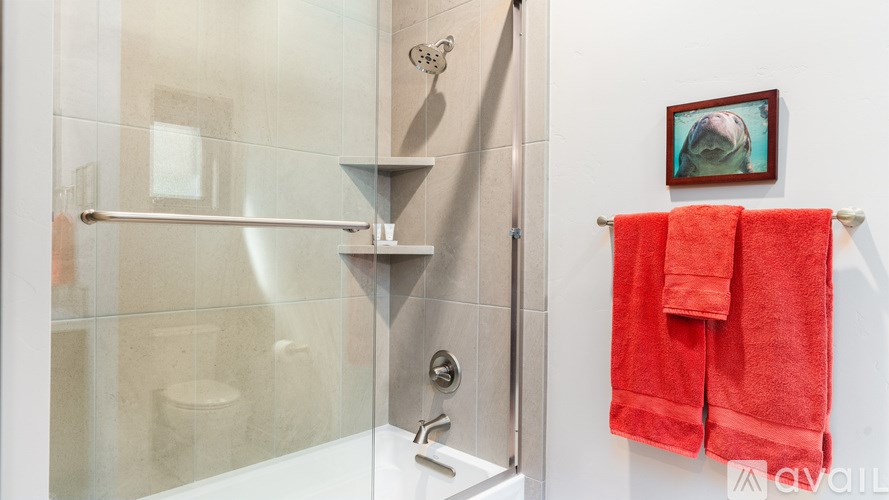 A red towel hangs on a towel rack in a modern bathroom.