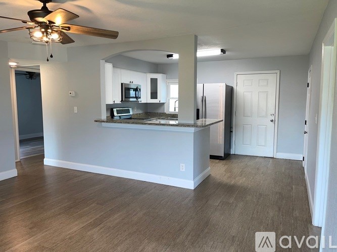 A kitchen with a counter and a fridge.