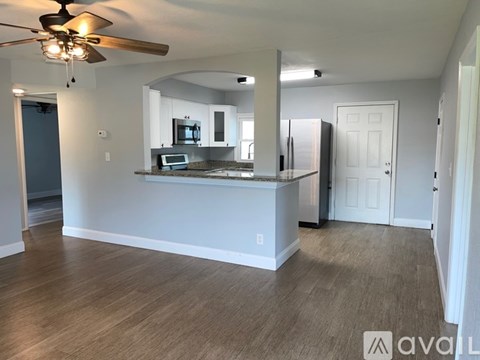 A kitchen with a counter and a fridge.