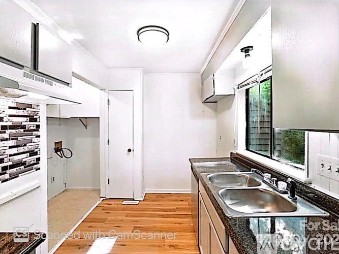 A kitchen with a sink and a window.