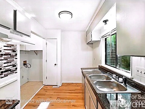 A kitchen with a sink and a window.