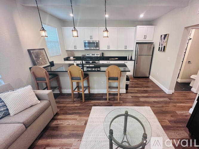A kitchen with a dining table and chairs in the middle of the room.