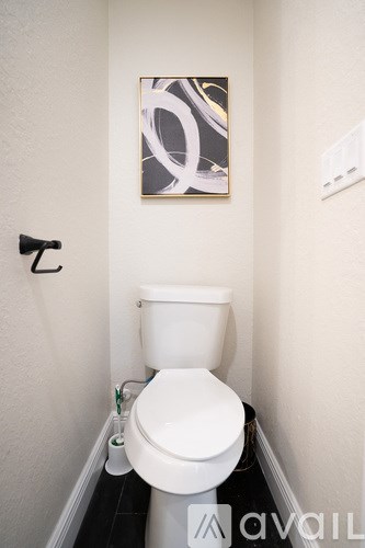 A kitchen with black countertops and white cabinets.