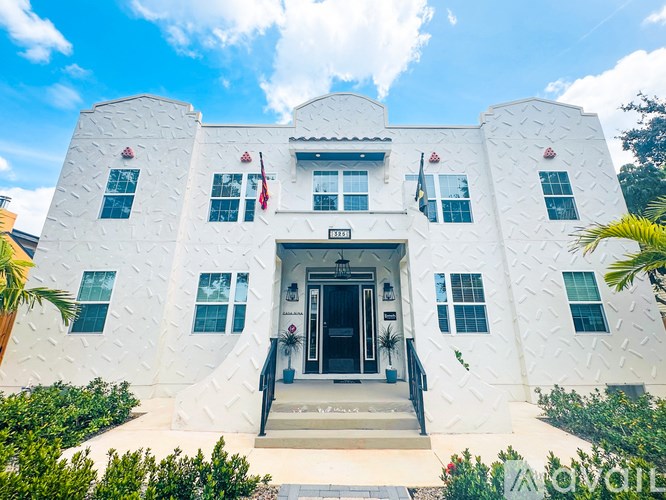 A white building with a flag on top and a sign that says "SANTA FE".