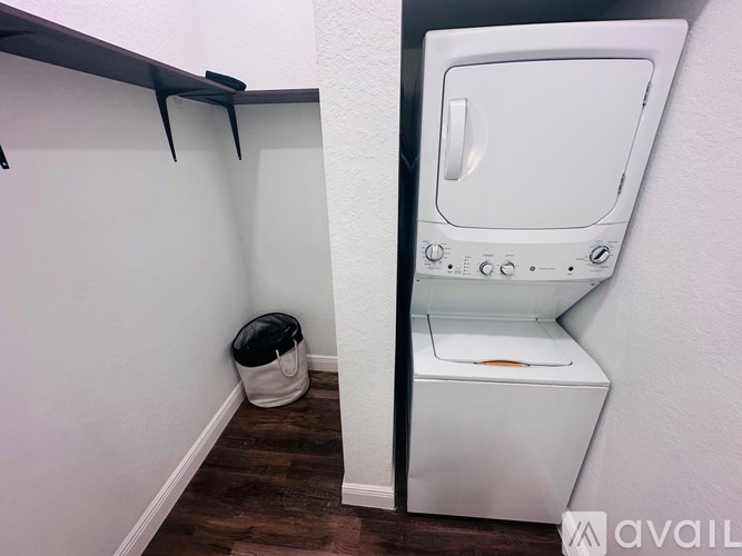 A white toilet with a white tank and a white wall behind it.