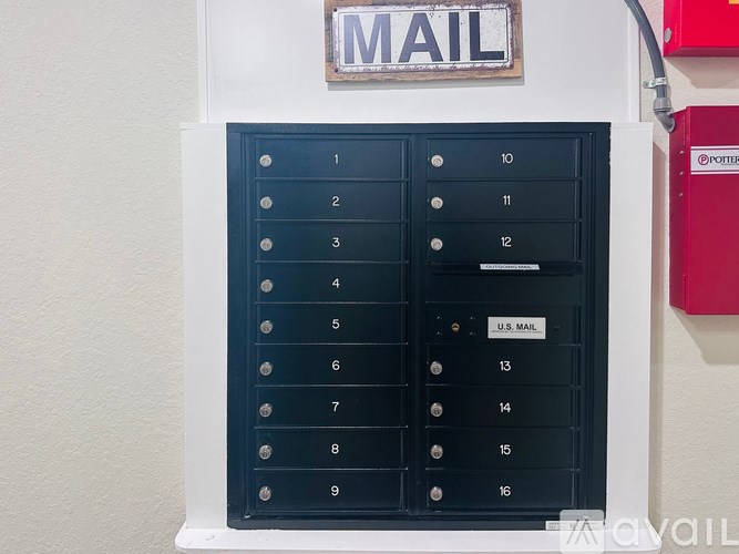 A mailbox with numbers 1 to 16 is mounted on a wall.