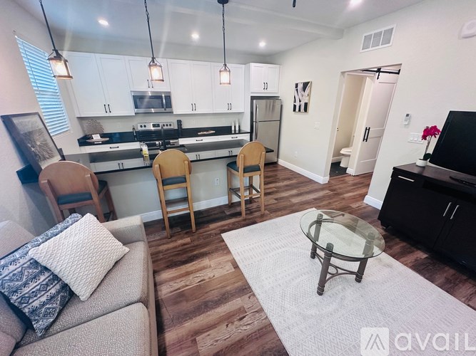 A modern kitchen with a dining table and chairs.