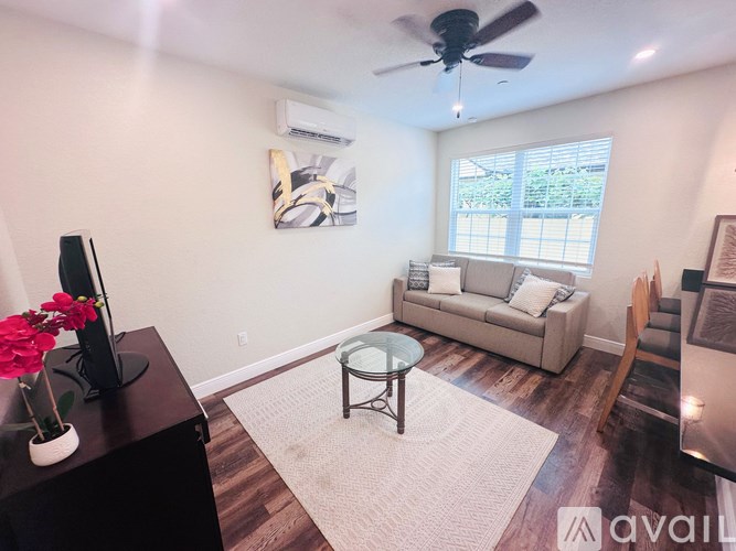 A living room with a couch, television, and a coffee table.
