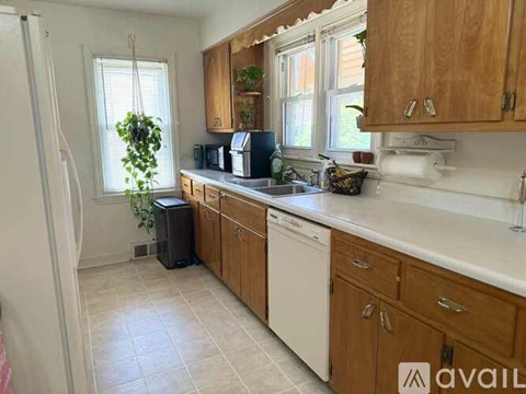 A kitchen with wooden cabinets and a white fridge.