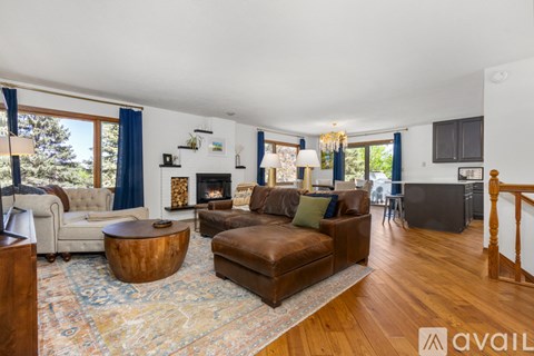A living room with a brown leather couch and a wooden coffee table.