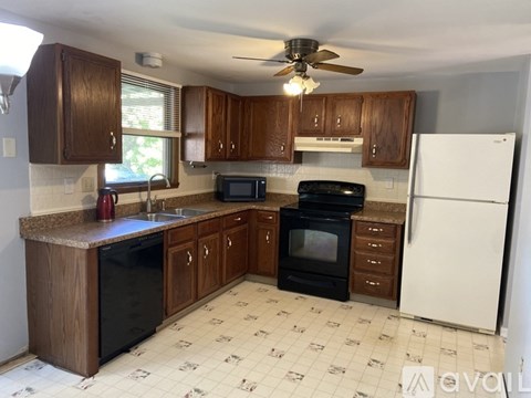 A kitchen with wooden cabinets and a white refrigerator.