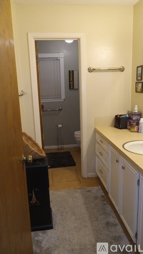 A bathroom with a sink, mirror, and toiletries.