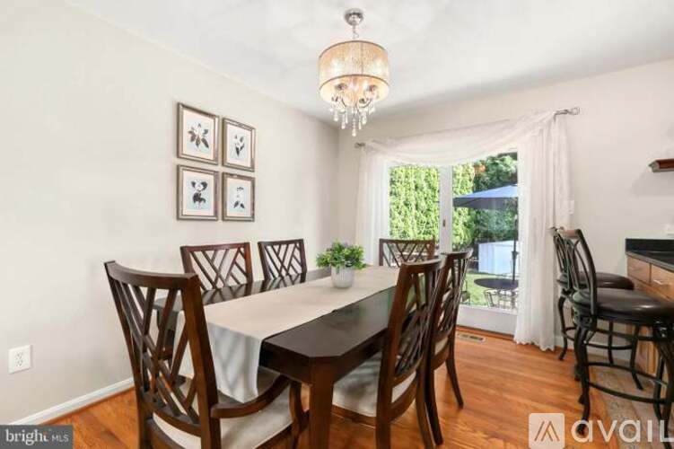 A dining room with a table set for four.