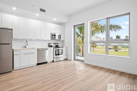 A kitchen with white cabinets and stainless steel appliances.
