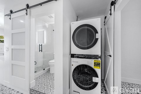 A modern kitchen with white appliances and cabinets.