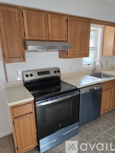 A kitchen with wooden cabinets and a stove top oven.