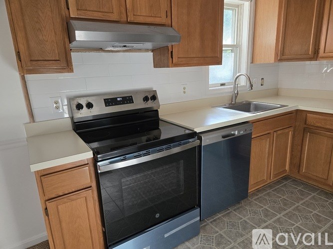 A kitchen with a stove and sink.