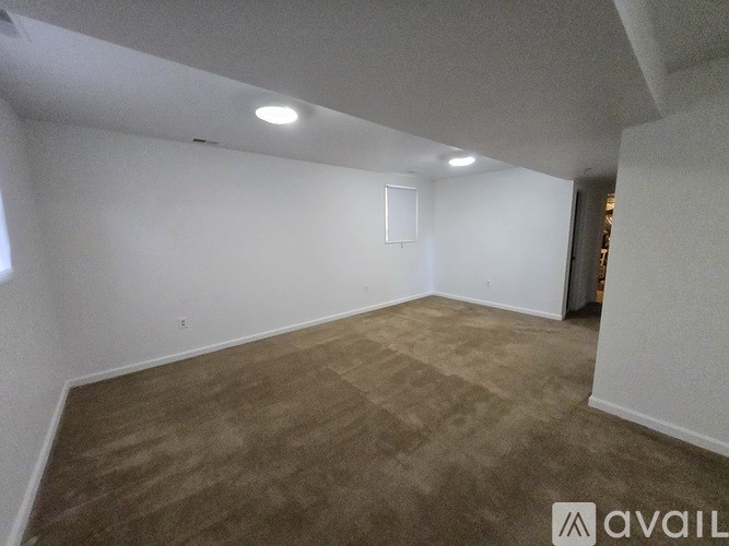 A room with a carpeted floor and white walls.