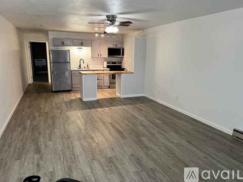 A kitchen with a refrigerator, stove, and sink is available for rent.