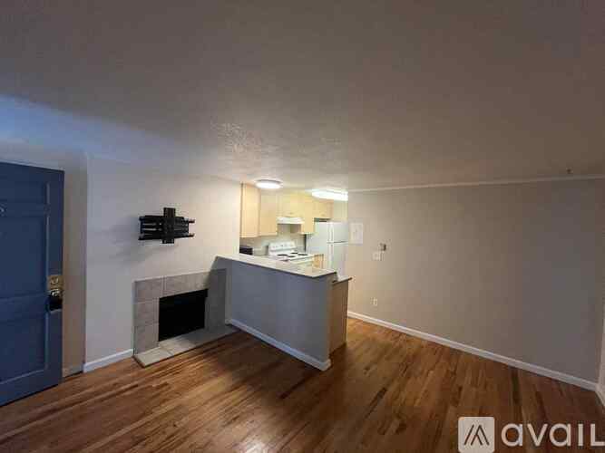 A room with a fireplace and a TV mounted on the wall.