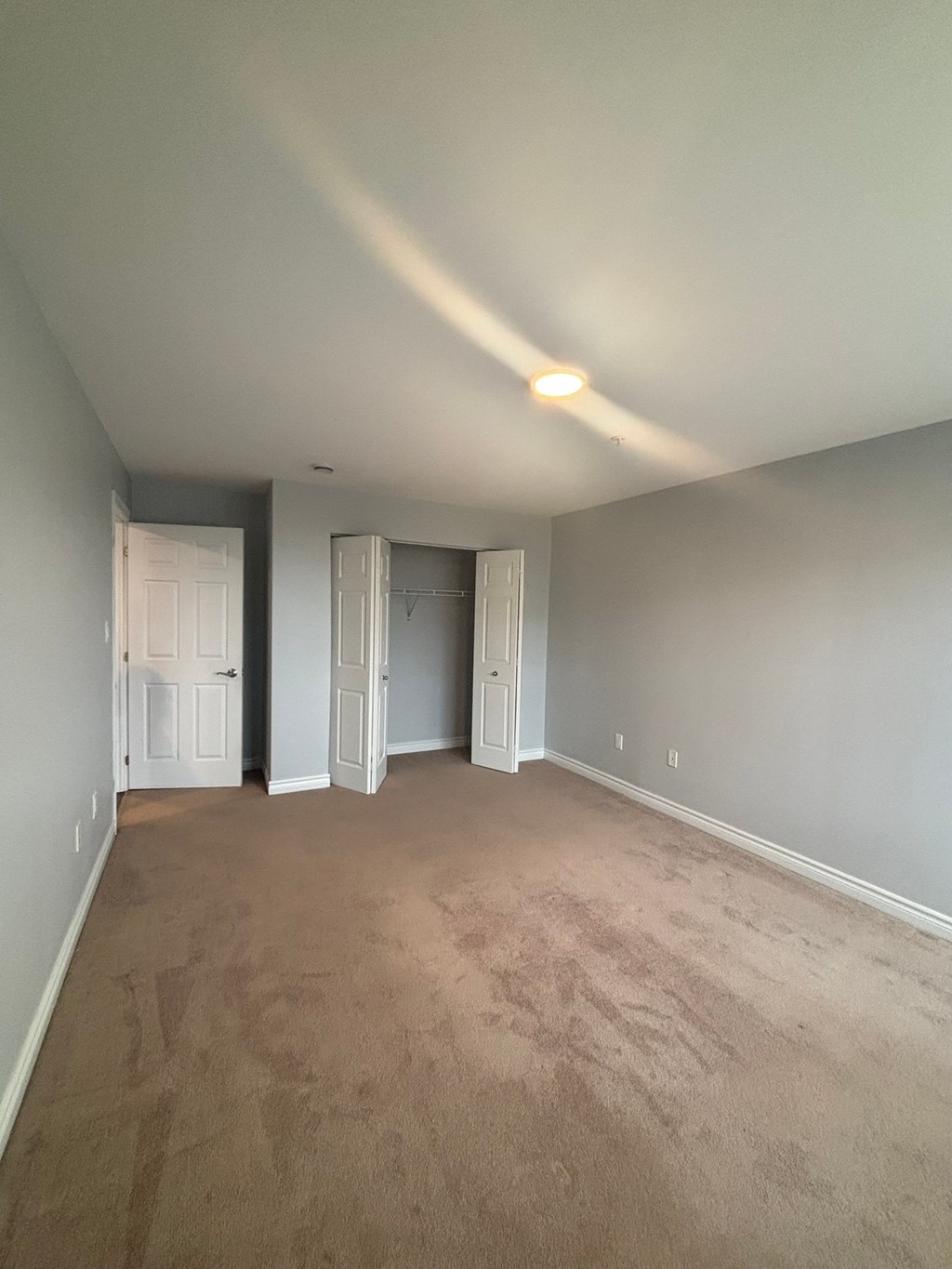 A room with carpeted floor and white walls.