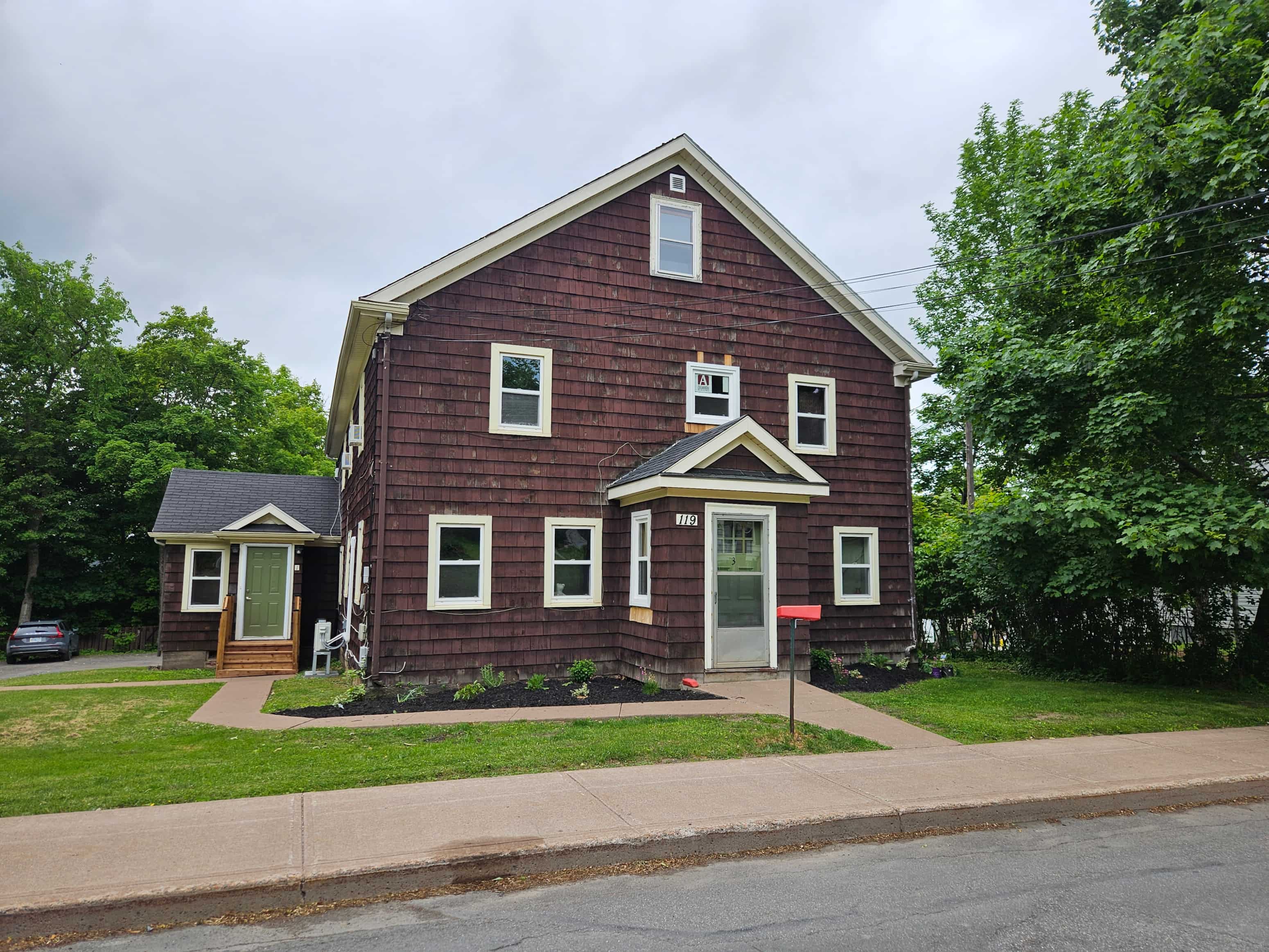 A red house with a white door and windows.