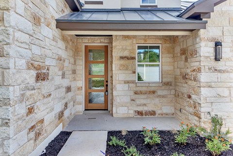 A house with a brown door and a window.