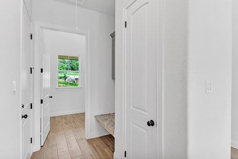 A white door with a black handle is on the right side of the image.