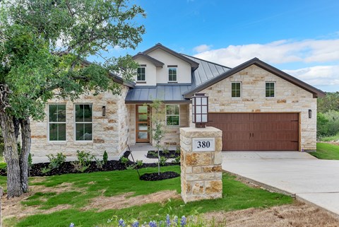A house numbered 380 with a garage door.