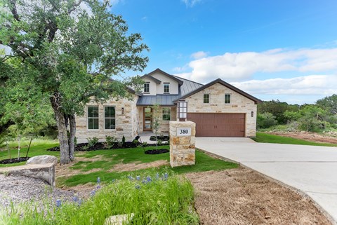 A house with the number 380 on a stone pillar in front of it.