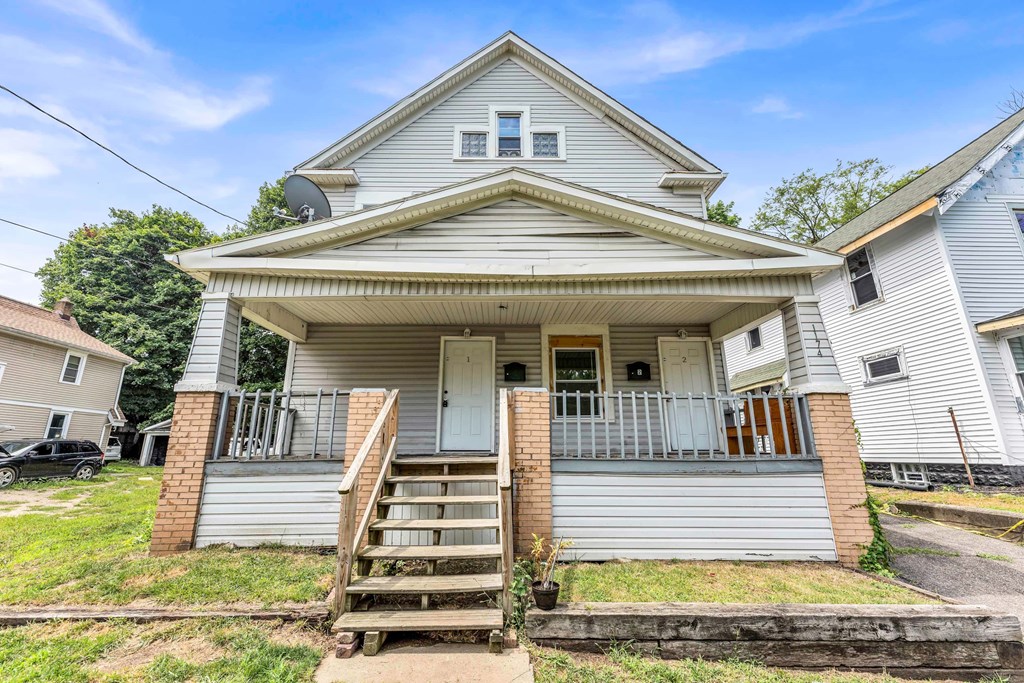 A house with a grey roof and a white front porch.