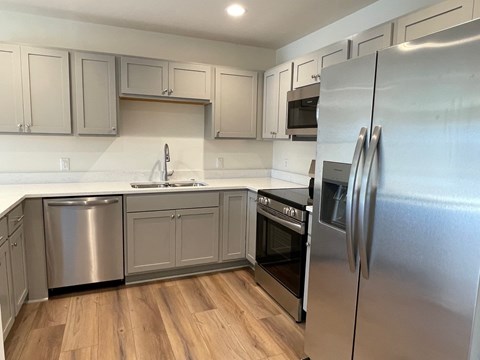 A kitchen with a refrigerator on the right.