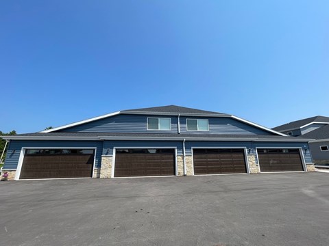 A large blue building with four garage doors.