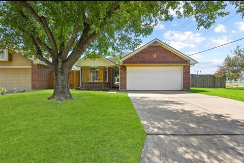 A house with a tree in front of it.