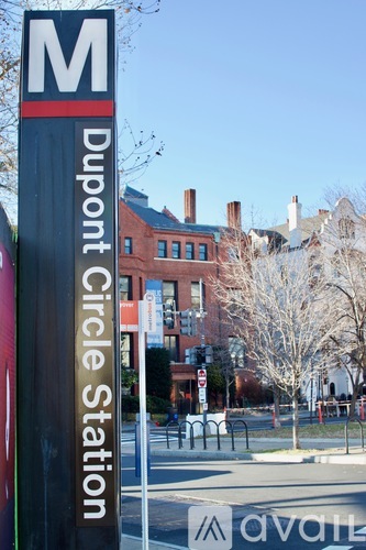 A sign for Dupont Circle Station is shown in front of a building.