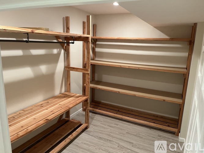 A wooden shelving unit with multiple shelves and a bench underneath.
