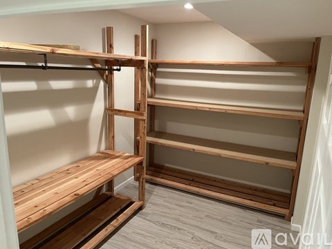 A wooden shelving unit with multiple shelves and a bench underneath.